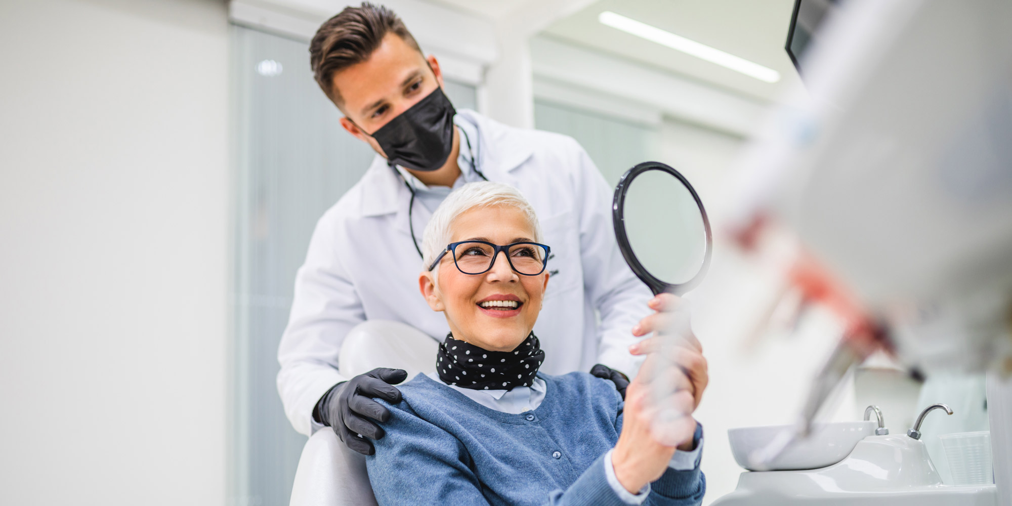 Very nice lady smiling at doctor happy with her teeth because she went to Bonvallet Dental