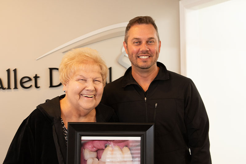 patient and doctor smiling inside of the dental center after procedure